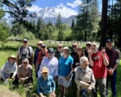 nature walk attendees pose in front of Mt Shasta at Luginbuhl Ranch Preserve.