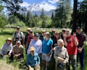 nature walk attendees pose in front of Mt Shasta at Luginbuhl Ranch Preserve.